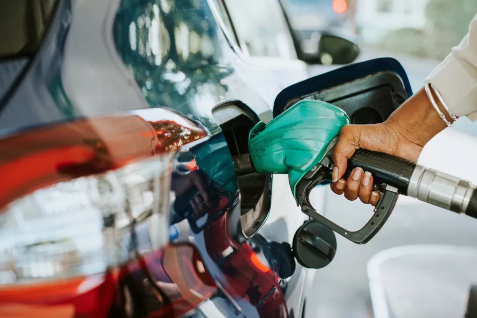 Close-up of hand filling car with gas at gas pump